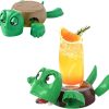 A whimsical Turtle Coaster Cup Pad and Mug Holder shown in two positions: one with a closed shell serving as a decorative hot pad, and another with an open mouth and wide eyes holding a glass of orange juice. This green and brown turtle drink coaster features a heat-resistant shell design, perfect for protecting surfaces from hot mugs or cold beverages