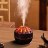 A sleek black 300ml ultrasonic essential oil diffuser and humidifier displays a vibrant red and orange flame effect emanating from faux glowing logs with a plume of white mist rising from its center.