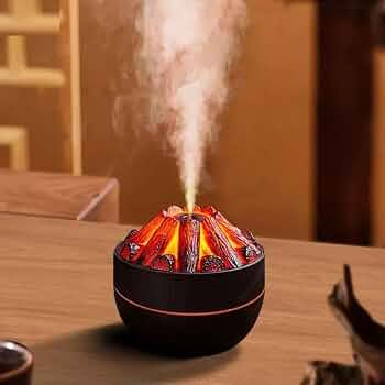 A sleek black 300ml ultrasonic essential oil diffuser and humidifier displays a vibrant red and orange flame effect emanating from faux glowing logs with a plume of white mist rising from its center.
