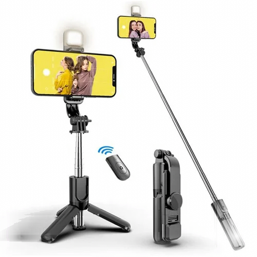The black R1S Selfie Stick with Integrated Flash and Multi-Color Light is shown in multiple configurations, including an extendable tripod stand with a mounted smartphone and illuminated LED fill light, a fully extended selfie stick, a folded compact unit, and a detachable wireless Bluetooth remote.
